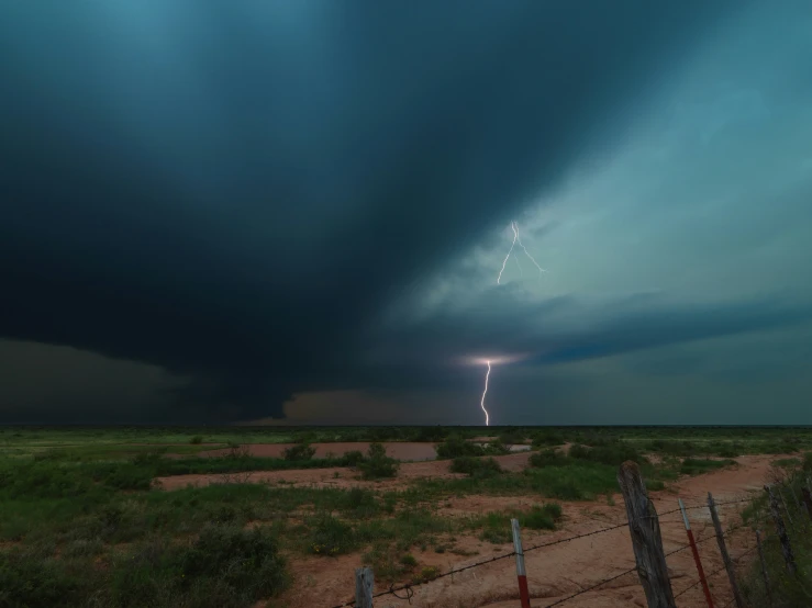 a large storm cloud with a lightning strike on it