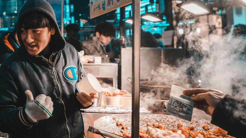 people look at a tray of food inside of a shop