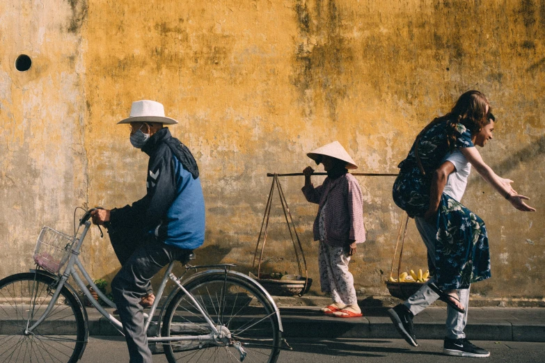 a group of three men riding bikes down a street