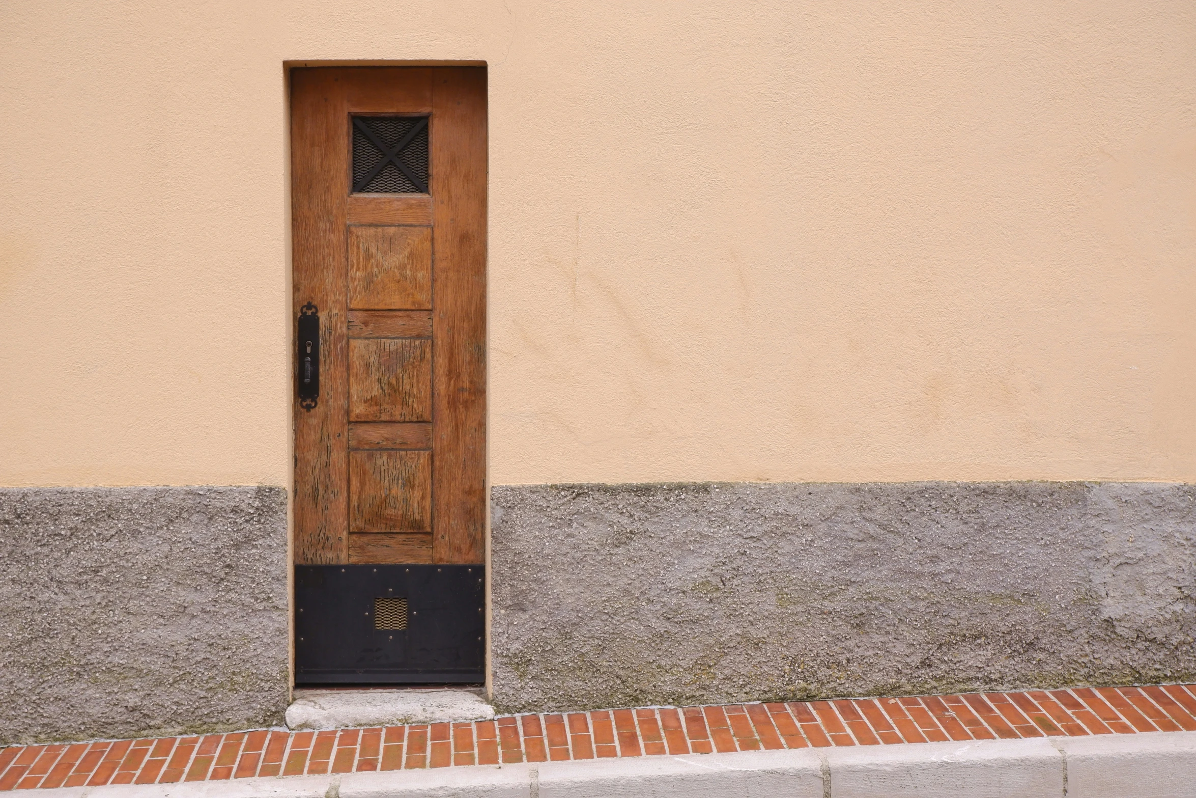 a door on the side of a yellow building