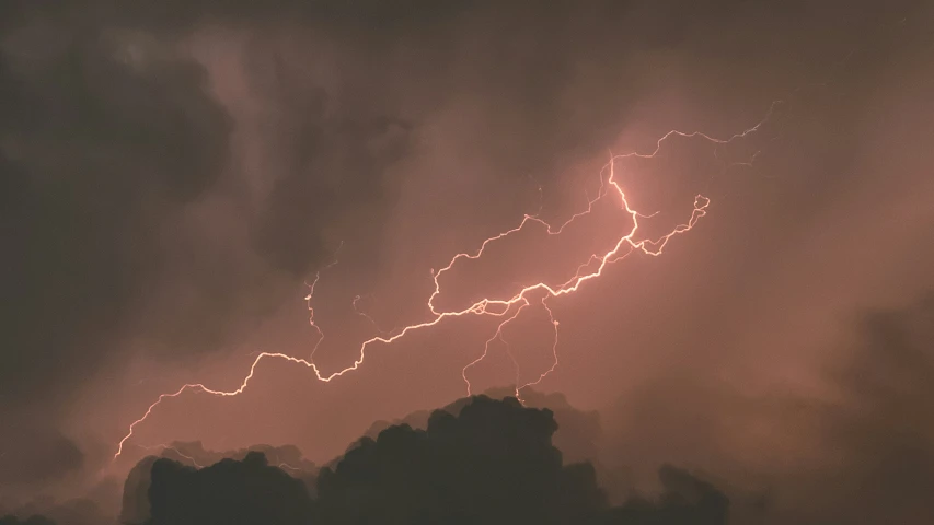 a couple of clouds that are under some lightning