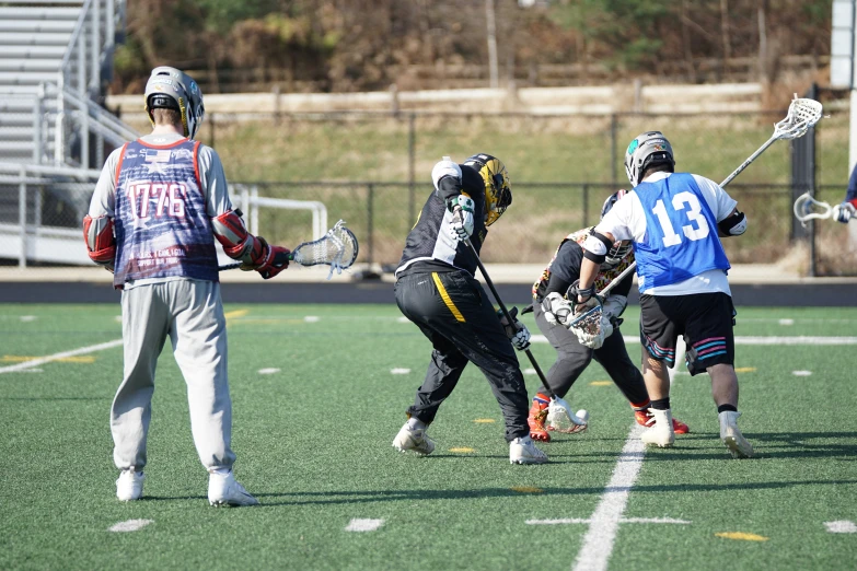 the group of boys are playing lacrosse together