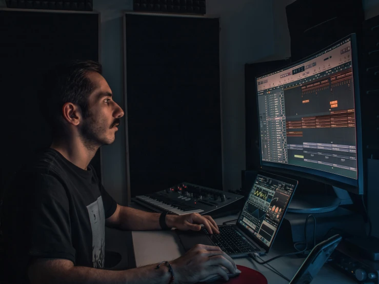 a man working on a computer in a recording studio