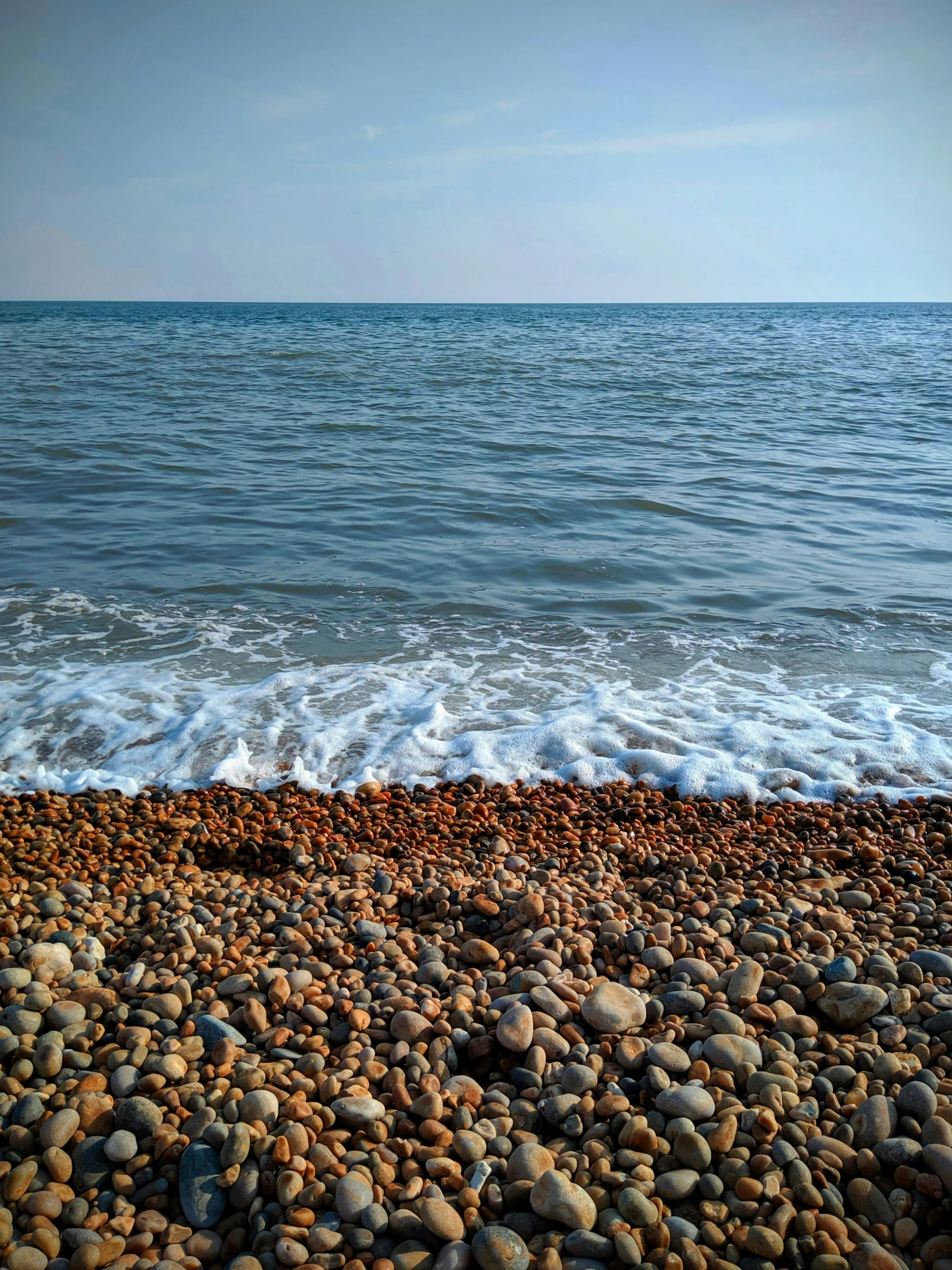 an ocean shore with water crashing on it