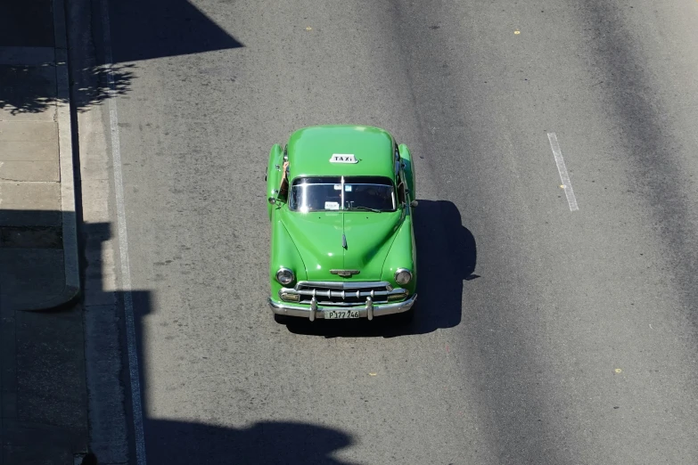 a large green truck driving down the street