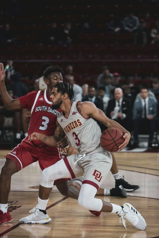 a man is running while being guarded by another player