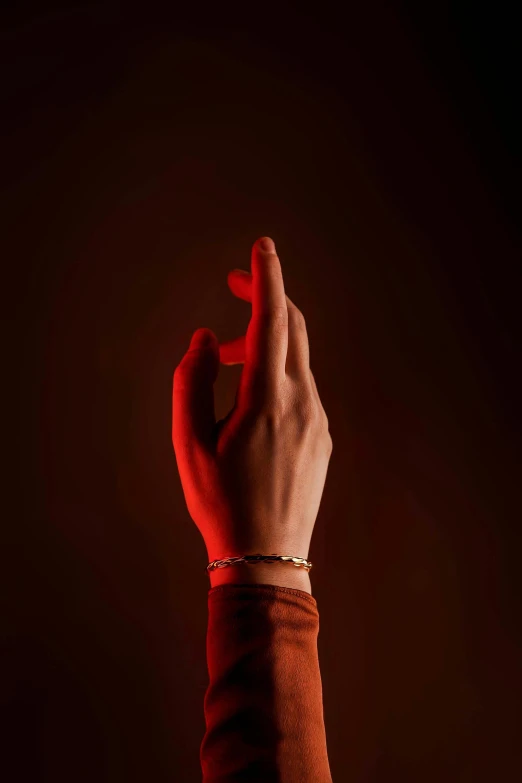 a hand with a band on it, in red light