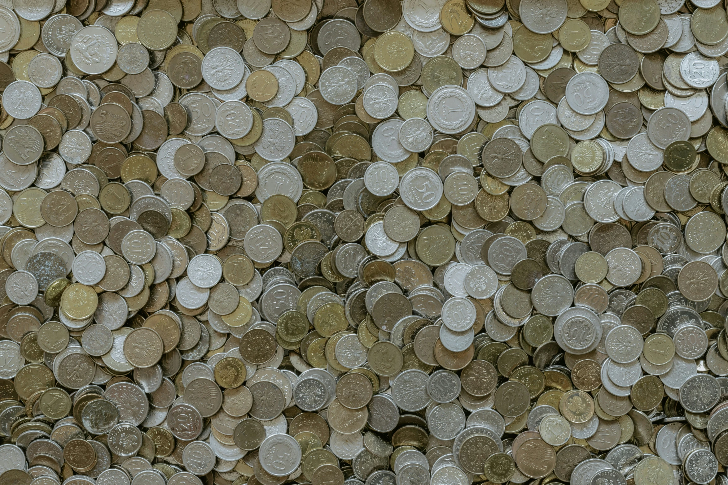 many small penny coins are scattered around the camera
