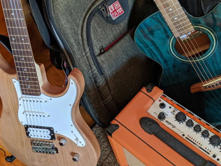 many guitars and amps are sitting next to each other