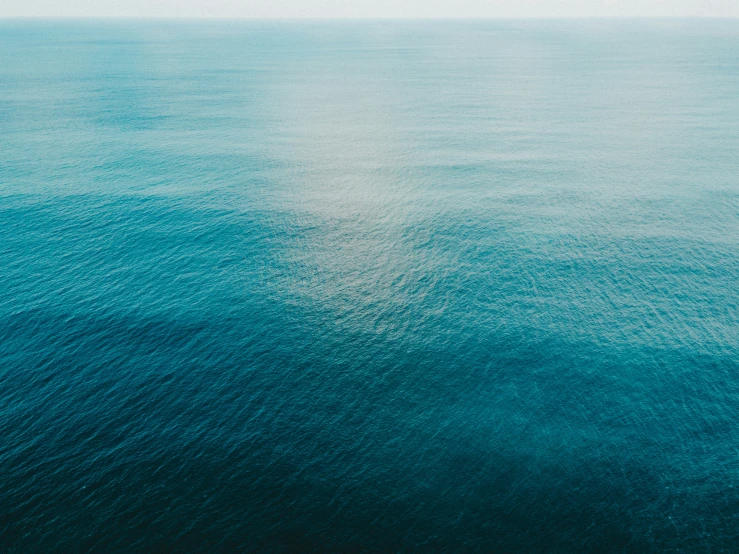 the ocean is crystal blue and turquoise, while water appears to have a shadow on it