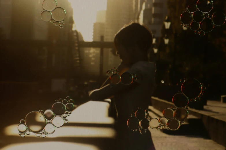 a woman standing next to a wall with soap bubbles on it