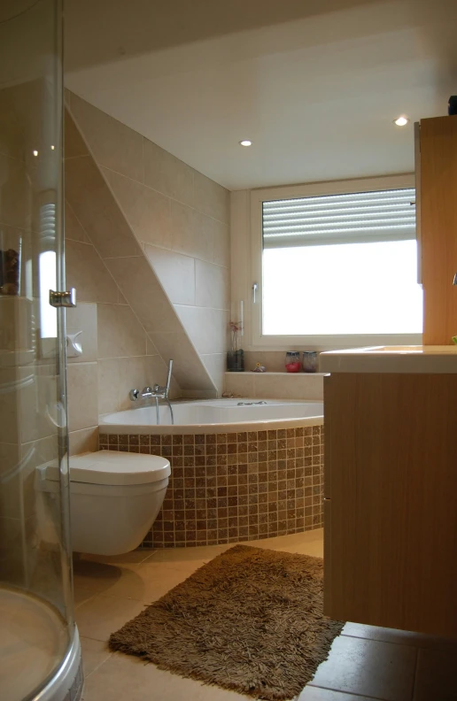 the bathroom is very modern with large tub and separate toilet