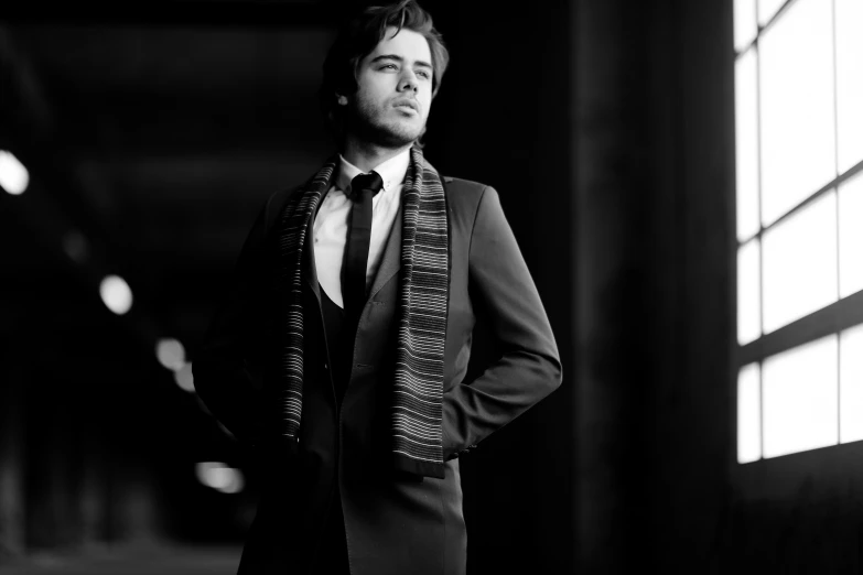 a black and white po of a man in a suit with a scarf