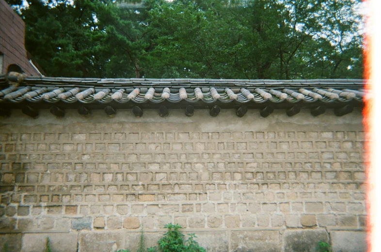 a brick wall has multiple pairs of shoes lined on top