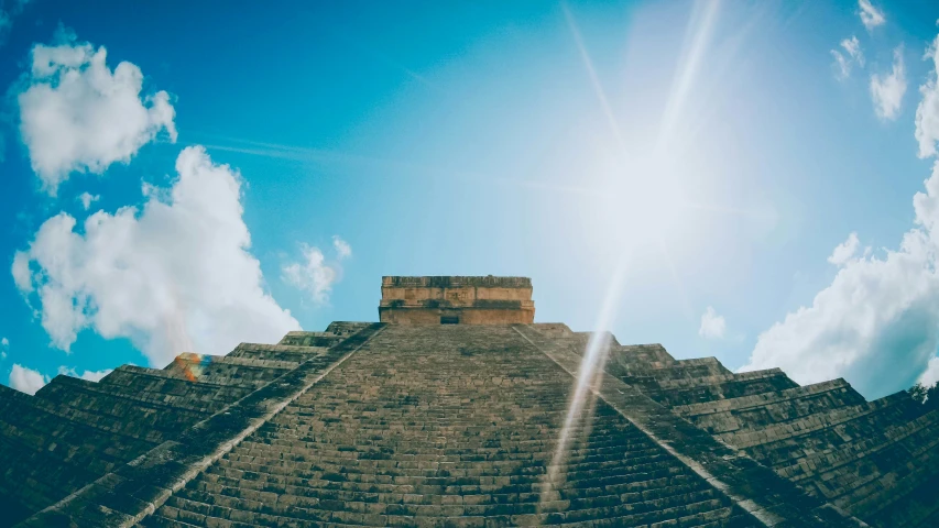 the sun shines brightly as it peeks through the sky at a pyramid