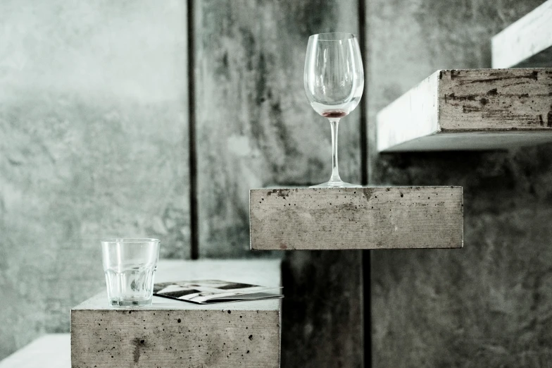 wine glasses with wine in each are on wooden crates