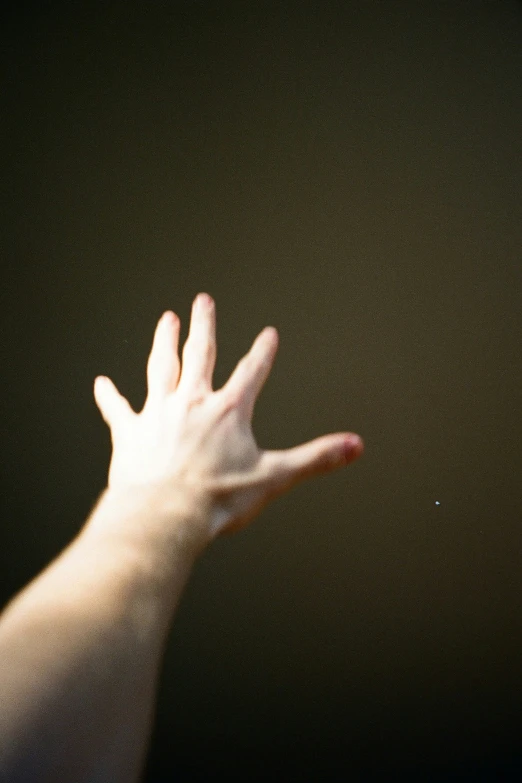 there is a hand in the air, with its palm outstretched