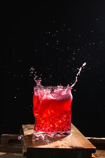 a splash of liquid is in a red liquid