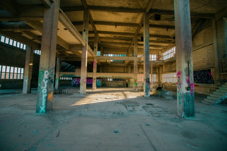 the inside of an abandoned warehouse with graffiti