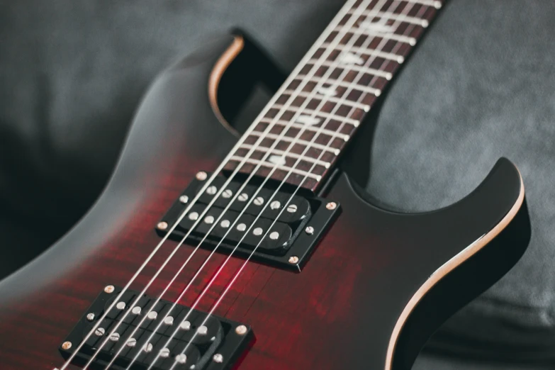 an electric guitar sits on a grey background