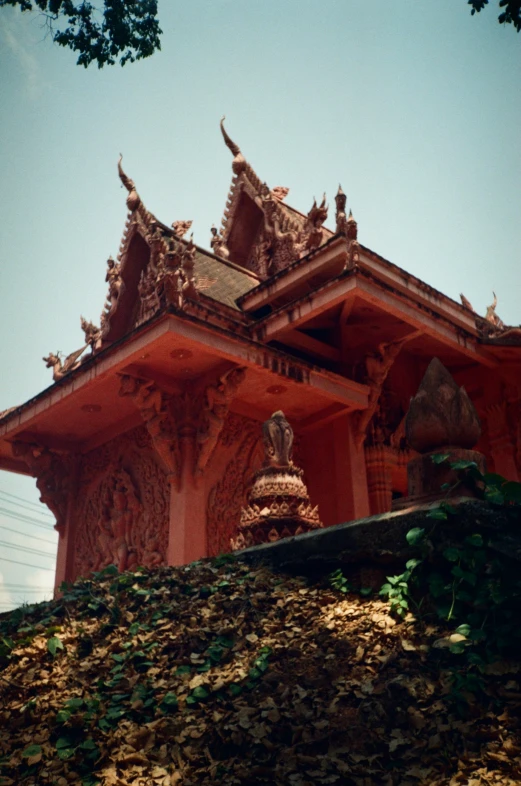 a building with statues and vines around it