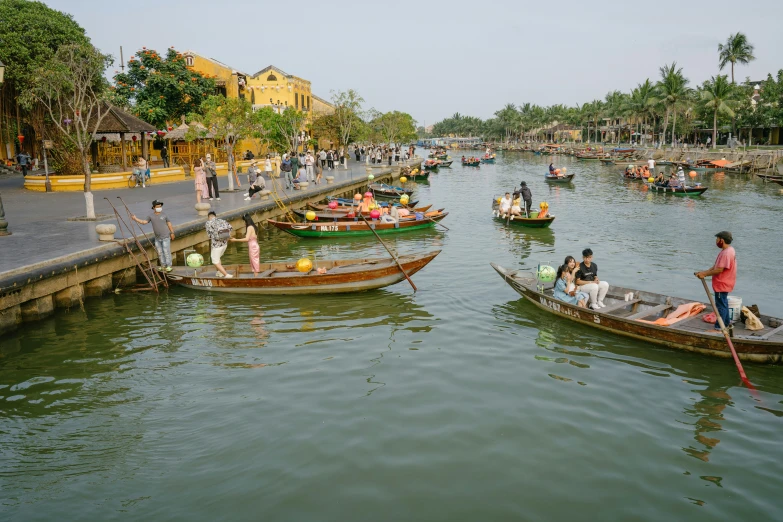 boats going down the river with several people sitting in them