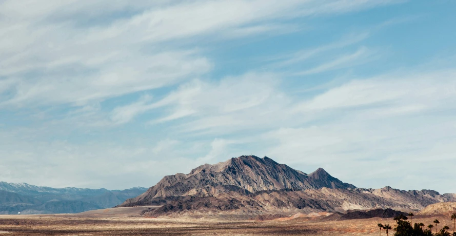 several tall mountains against a bright blue sky