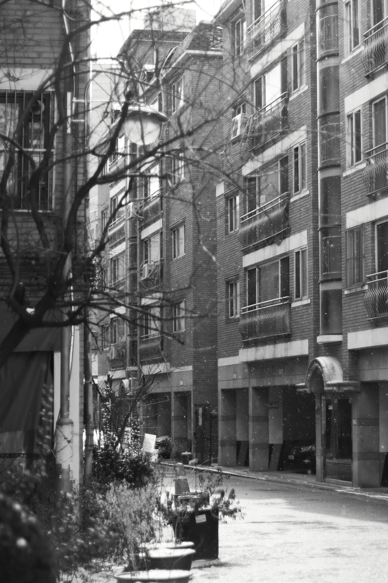 a black and white image of several buildings with balconies on the sides