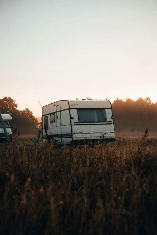 a white rv parked next to another travel trailer