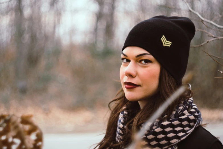 a woman wearing a beanie and a scarf