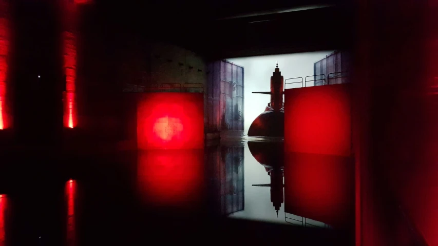 a dark corridor with red lights and reflection