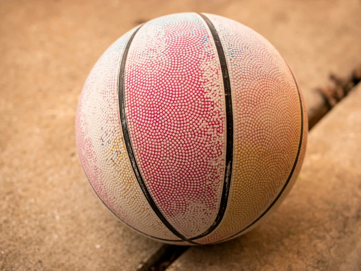 an artisticly painted ball on the pavement