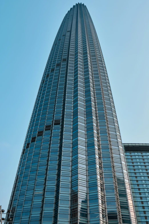 the top of a tall building near a building with a red traffic light on it