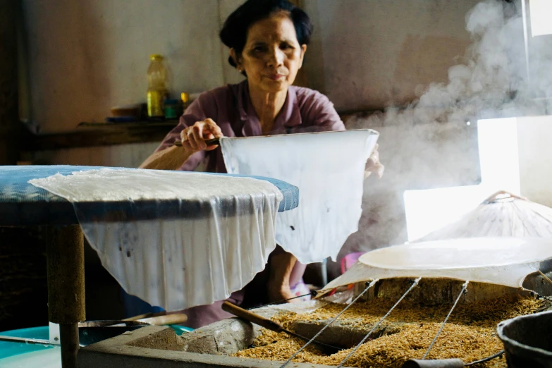 an old woman holding soing in her hands