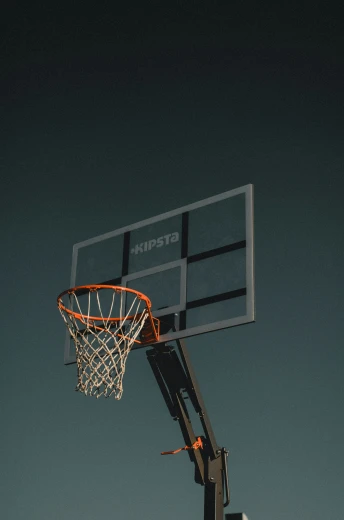 an orange basketball hoop on the back side of a court