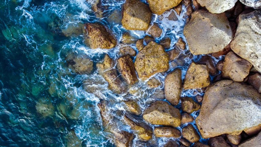 the water and rocks are near a shoreline