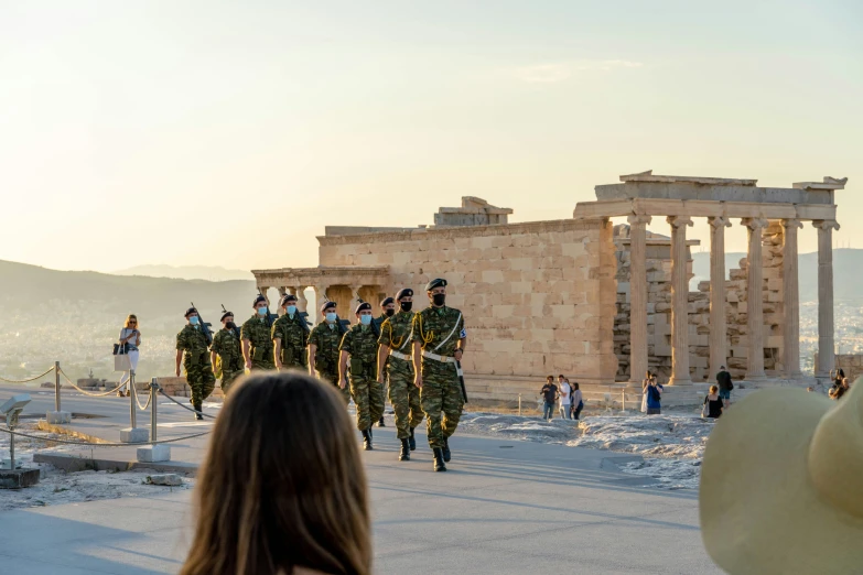 a group of soldiers walking around in front of the parthenion