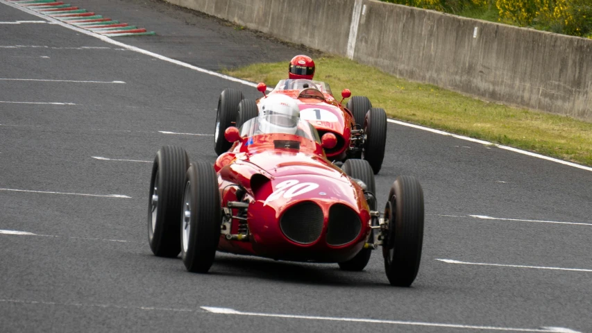 two race cars going around a corner on a track