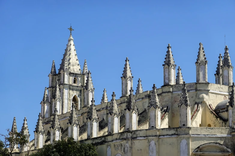 a church with ornate towers and steeples with a clock in the middle