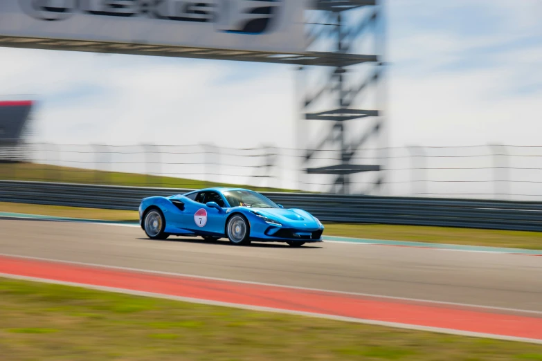 blue sports car on track in the day time