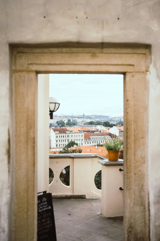 a window view of buildings, a street and a lamp