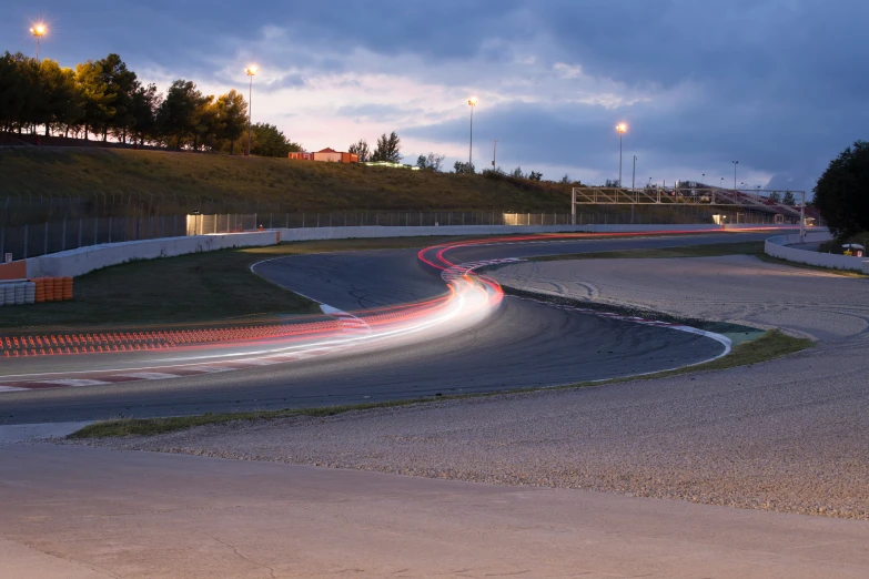 a night time race with lights streaking through the track