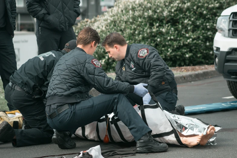 two men are setting up a package on the side of a street