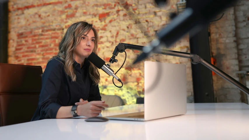 a woman is on a radio with a microphone