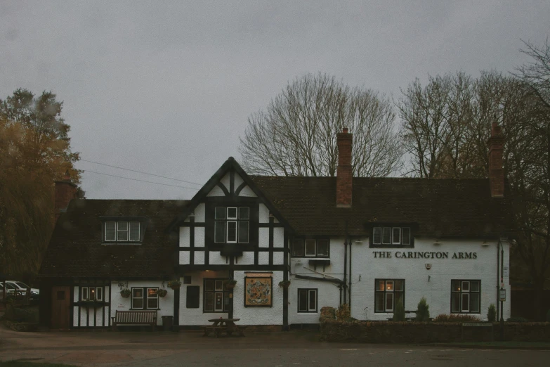 a white building with windows next to trees