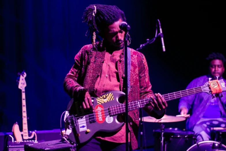 an image of a man playing a bass guitar