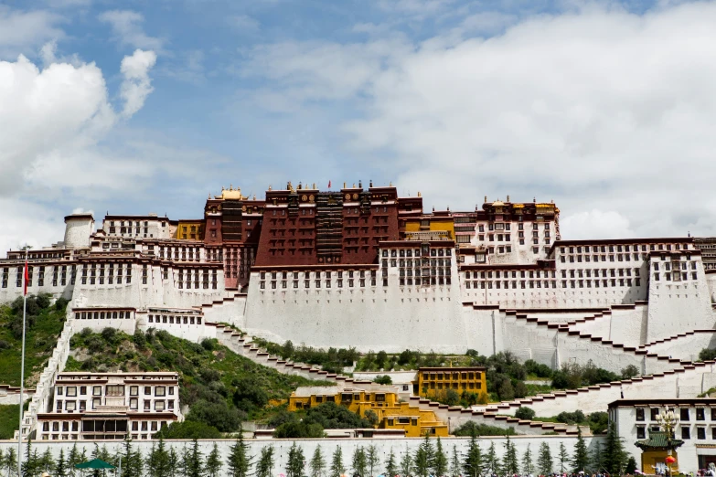 large building sitting on top of a white hill