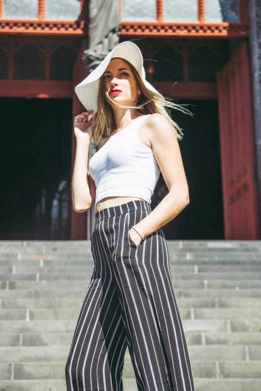 a woman posing on steps in front of a building