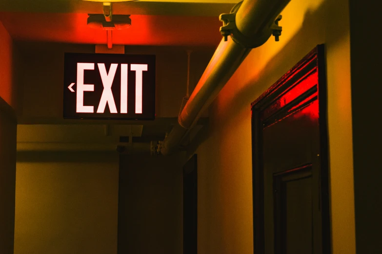 a hallway has a exit sign in it