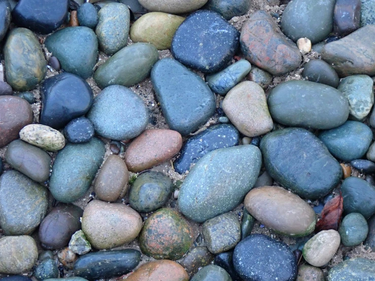many different colored rocks on the ground